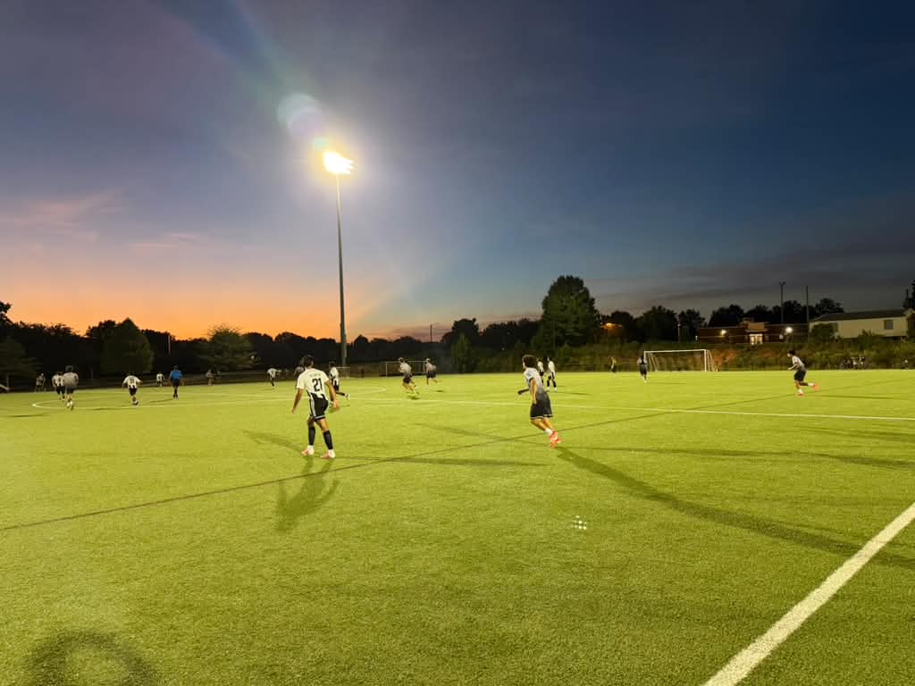 NC United FC players competing under the lights against Queen City Mutiny.