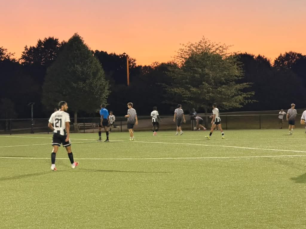 NC United FC and Queen City Mutiny players during the September 9 preseason match at sunset.