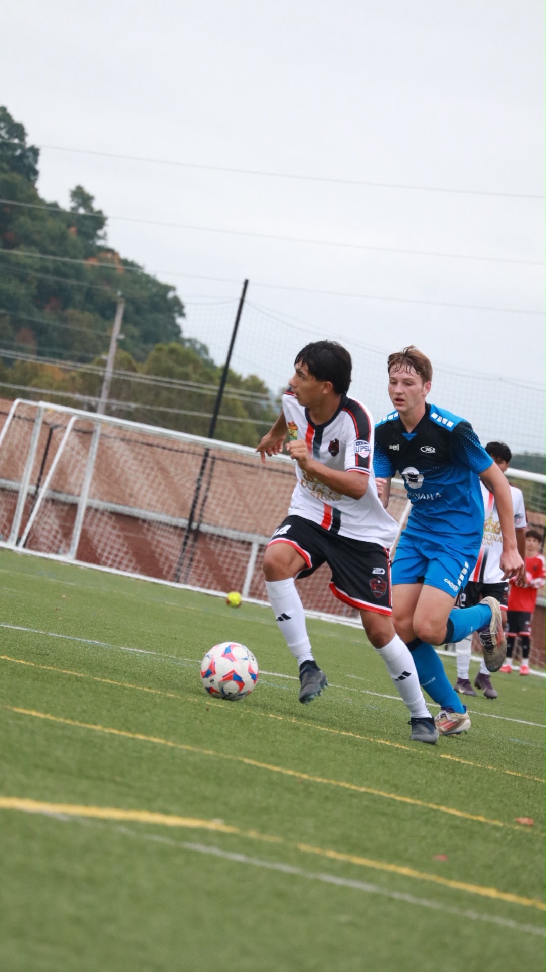 NC United FC U17 Academy player carrying the ball with a Rush United opponent alongside during the October 4 match in Radford.