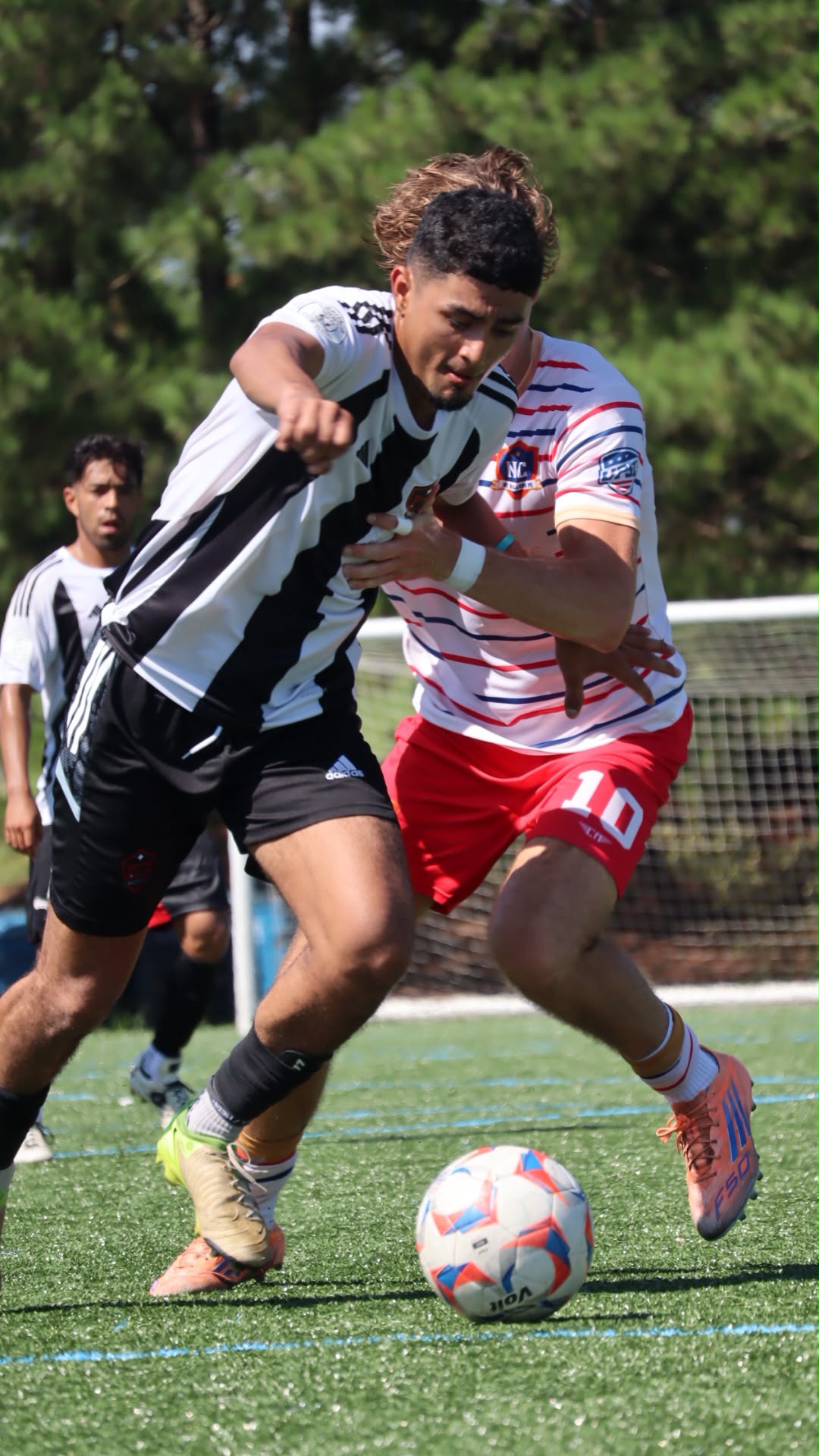 NC United FC player shielding the ball from an NC Ballers defender during the August 8 preseason friendly