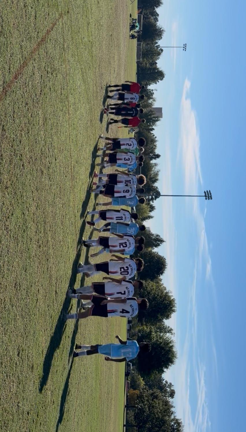 NC United FC U17 Academy players walking onto the field alongside their opponents and the match officials.